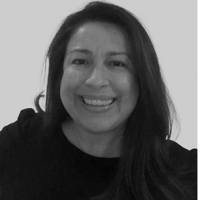 Smiling woman with long dark hair in a black top, against a plain background.